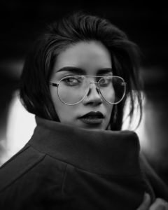 Black and white image of woman wearing glasses